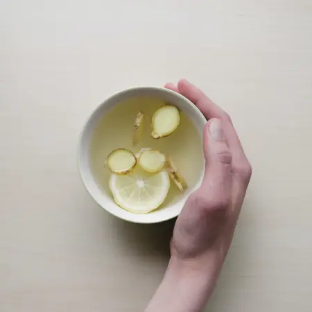 Ginger and lemon tea at night to reduce belly bloating