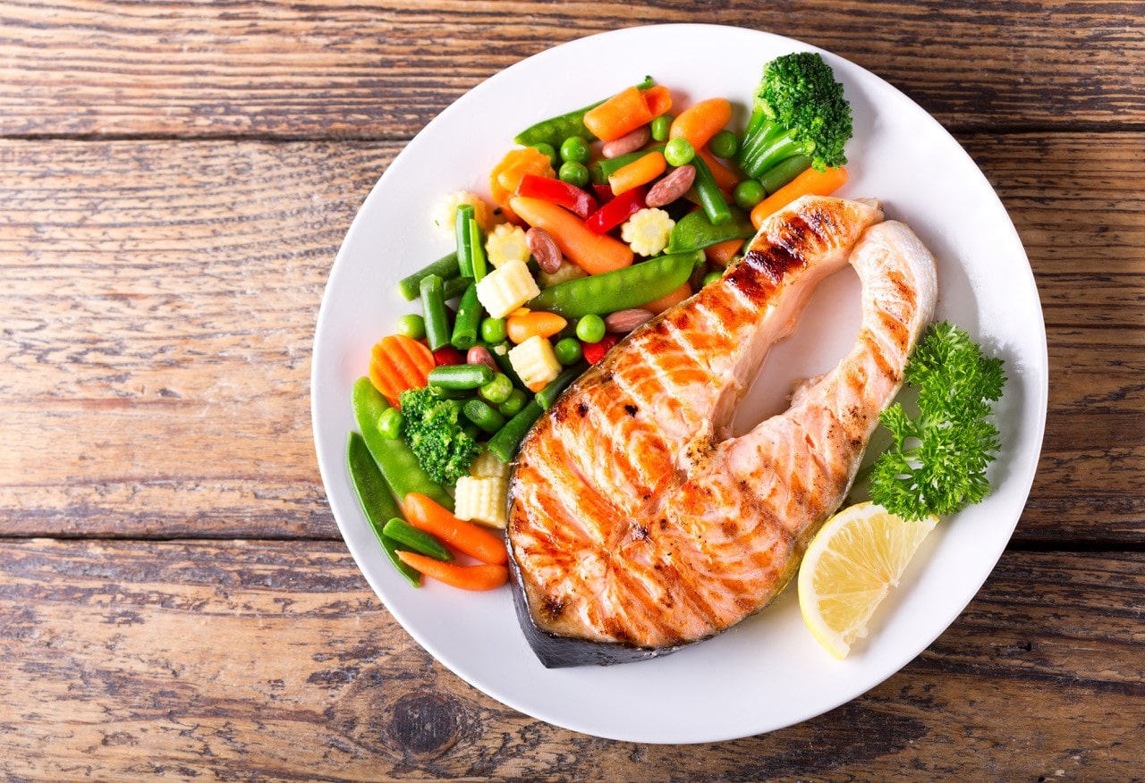Plate with a variety of vegetables and grilled salmon